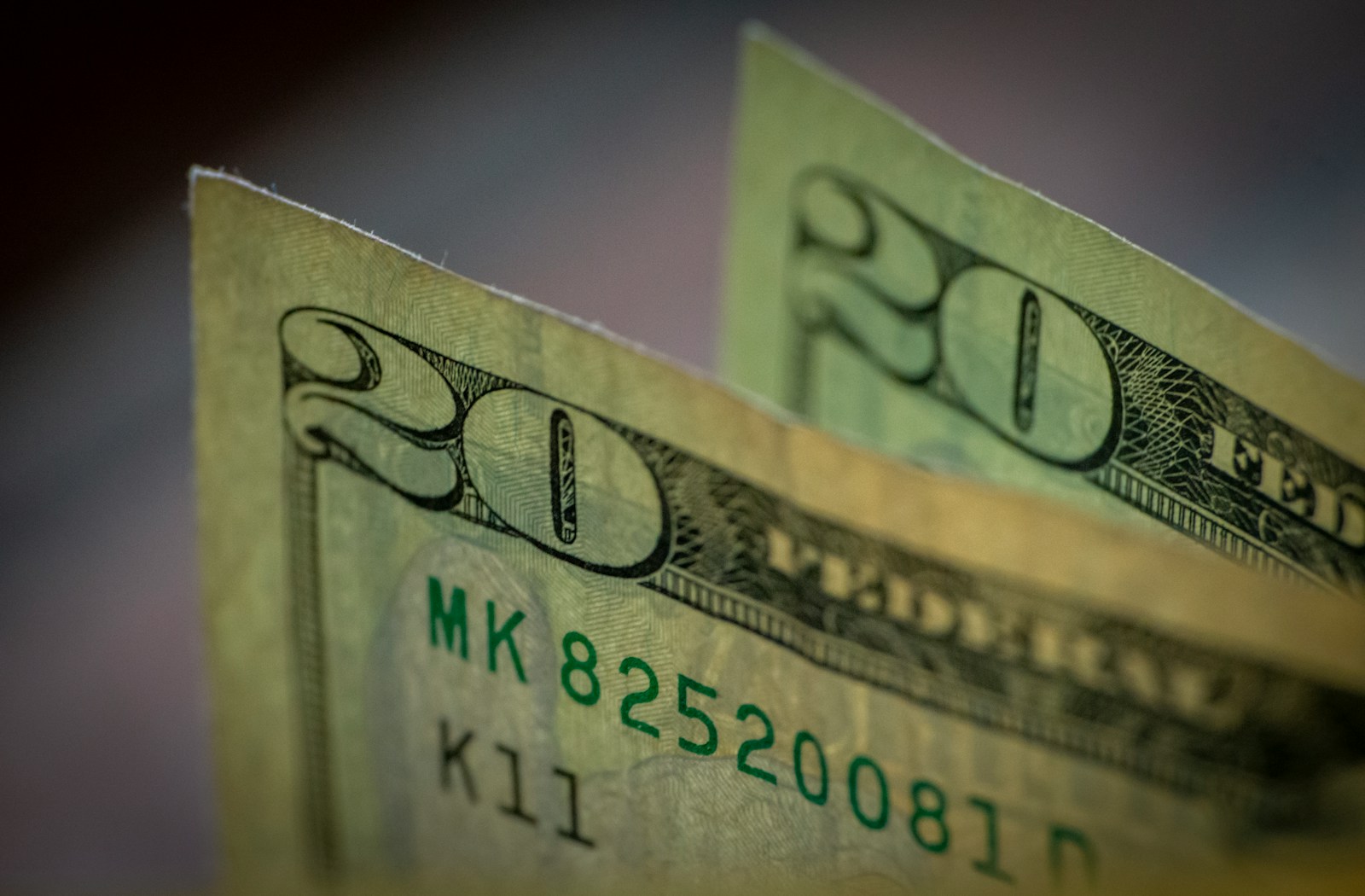 two stacks of twenty dollar bills sitting on top of each other